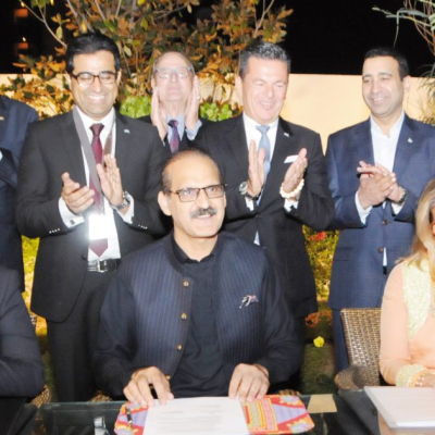 Bavarian Business Delegation to Pakistan, October 2018: Front: Ahsan Mehmood Baba, Politician and President Lions Club Chillianwala, Patricia Poetis, CEO, Life Fund Equity Invest and founder of Lions Club Chillianwala, signing an agreement of Patty‘s Child Clinics Pakistan with Aamir Mehmood Kiani, Federal Minister for National Health Services, Regulation and Coordination. In the background are Mr. Rieger, Head of Delegation, Murad Mehmood, Manager of Business Delegations, Honorary Consulate of the Islamic Republic of Pakistan, Prof. Dr. Dr. Walter Schmidt, Managing Director, InterMedia, Honorary Consul Dr. Poetis, Khurram Jameel, Managing Director & CEO, Siemens Healthineers, Sikander Mir- Kohler, Former Honorary Investment Counsellor, Board of Investment, Pakistan